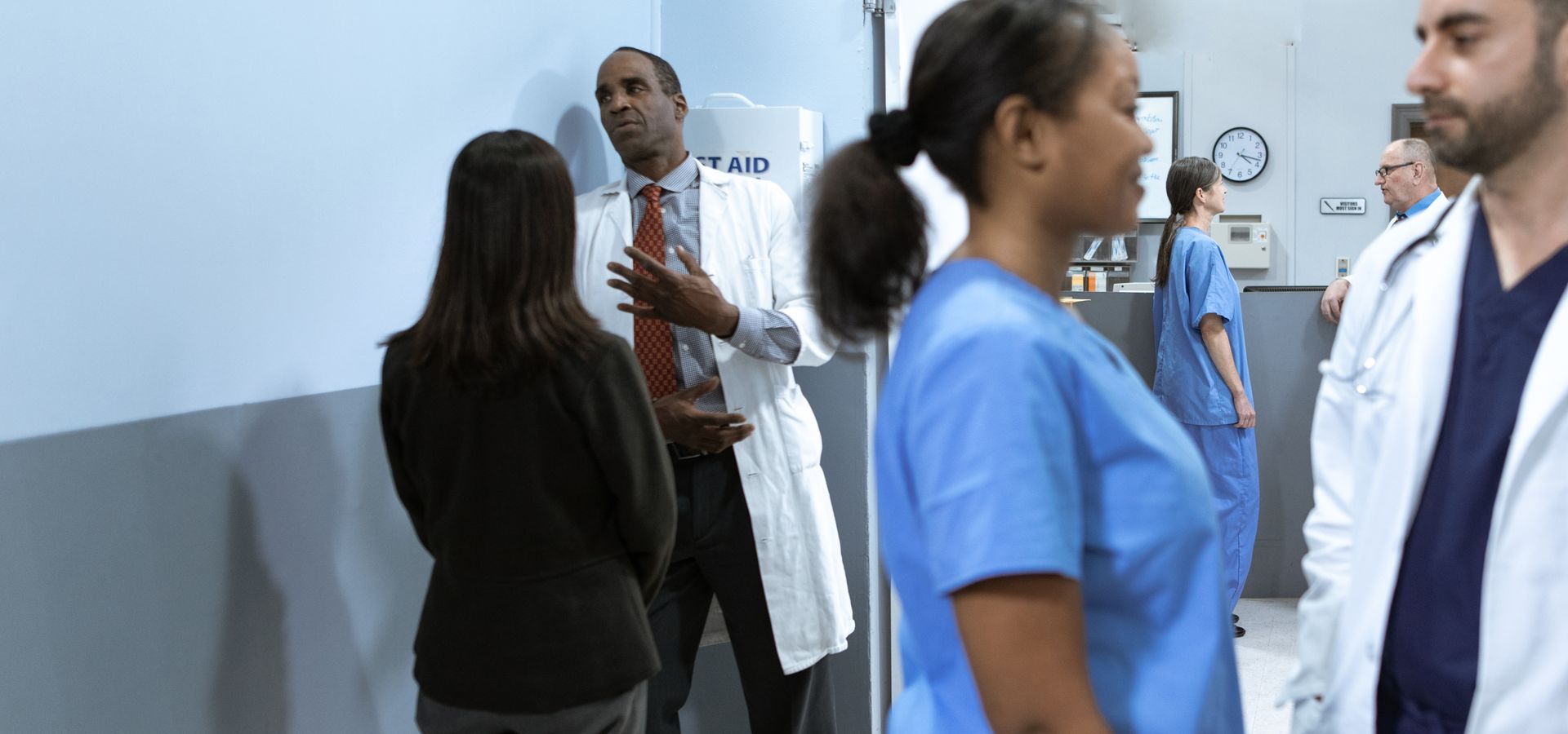 Business professional meeting a doctor in a hospital corridor